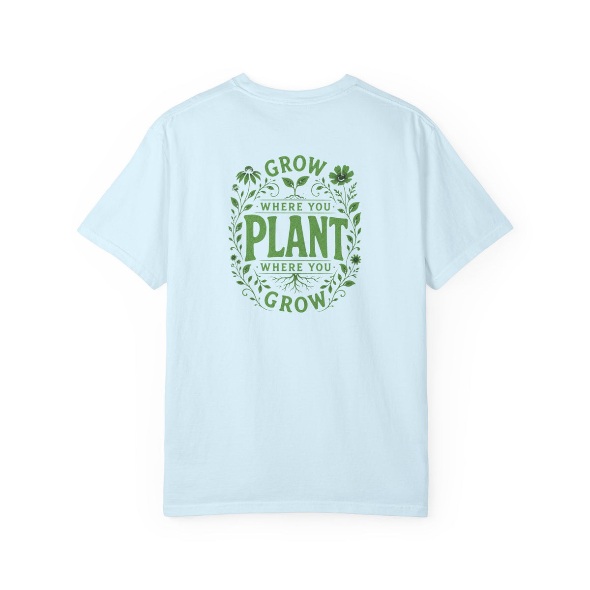 An light blue short-sleeve t-shirt with a green graphic on the back reading 'GROW WHERE YOU PLANT WHERE YOU GROW' surrounded by leaves and clovers, shown against a plain white background.