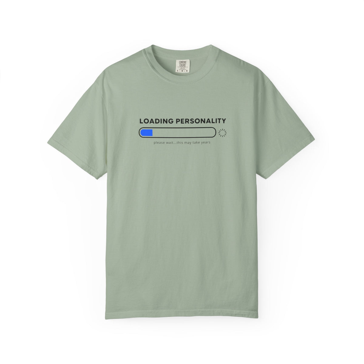 A sage green short-sleeve t-shirt with a graphic on the chest that reads 'LOADING PERSONALITY' above a progress bar with a blue filled segment and the text 'please wait.