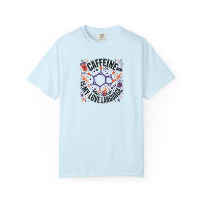 A light blue short-sleeve crewneck t-shirt featuring a colorful graphic print on the front with a chemical structure, the word 'CAFFEINE', and the phrase 'IS MY LOVE LANGUAGE' in stylized lettering.
