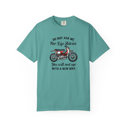 A teal short-sleeve t-shirt with a graphic of a red and white scooter and the text 'DO NOT ASK ME For Life Advice You will end up WHITH A NEW BIKE' printed on the front, displayed on a clean white background.