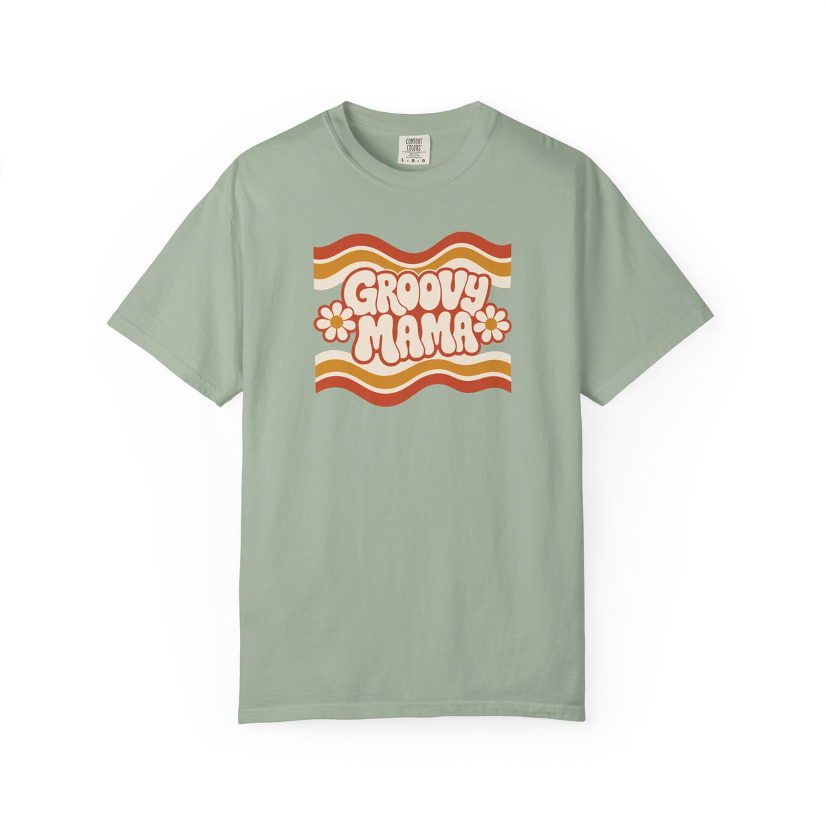 A sage green short-sleeve t-shirt with a retro 1970s-style graphic on the chest reading 'Groovy Mama' in pink bubble letters, set against wavy orange, yellow, and white stripes with small daisy accents.