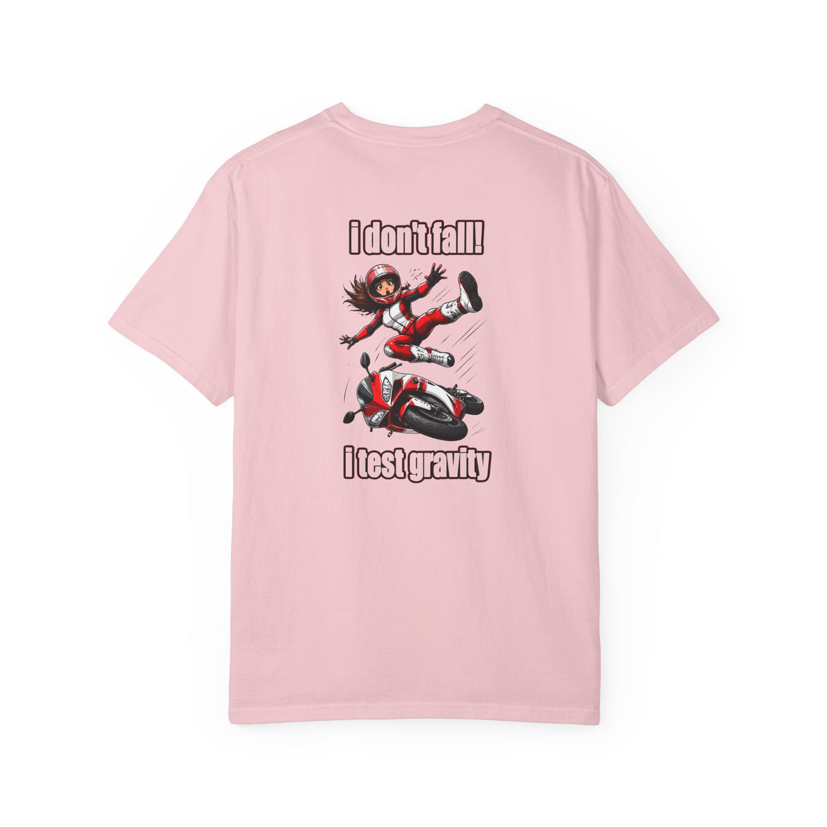 A light pink short-sleeve t-shirt with a graphic print on the front. The graphic features an anime-style character falling off a red and black motorcycle, with the text 'I don't fall!' above and 'I test gravity' below.