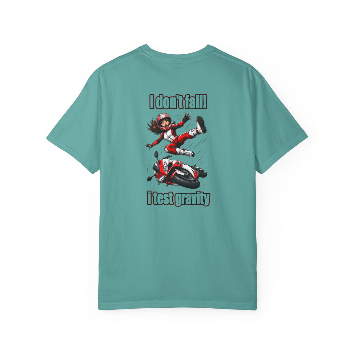 A teal short-sleeve t-shirt with a graphic print on the back showing a cartoon girl falling off a motorcycle with the text 'I don't fall' above and 'I test gravity' below.