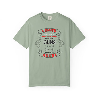 A bay short-sleeve crewneck t-shirt with a graphic print on the front. The graphic features the text 'I have a beautiful daughter,i also have guns, a shovel and a strong alibi' in black and red lettering, accompanied by illustrations of two pistols and a shovel.