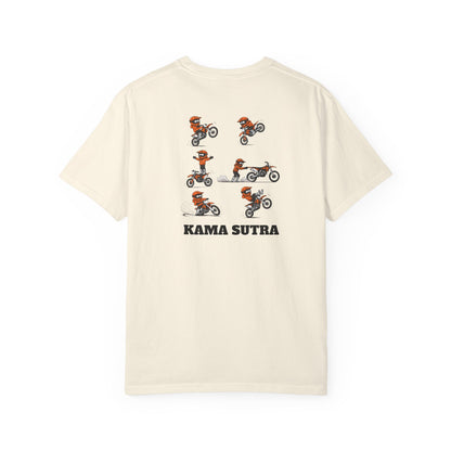 An off-white short-sleeve t-shirt with a graphic print of a motocross rider in orange and black, showing multiple riding poses, with the text 'KAMA SUTRA' printed below in black.