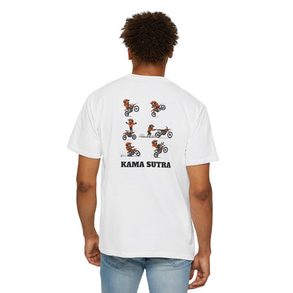 A man wearing a white short-sleeve t-shirt with a graphic print of a motocross rider in an orange and white KTM suit performing a jump, with the text 'KAMA SUTRA' printed below in black.