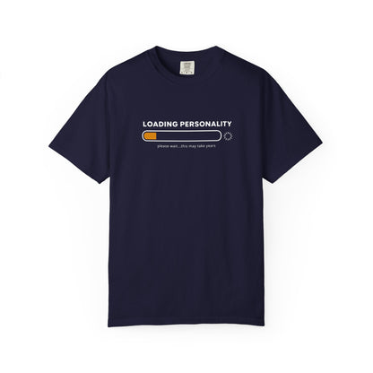 A navy blue short-sleeve crewneck t-shirt with a graphic on the chest that reads 'LOADING PERSONALITY' above a progress bar with an orange filled segment and the text 'please wait'.