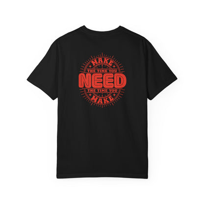 A black short-sleeve crewneck t-shirt with a red circular graphic on the back that reads 'MAKE THE TIME YOU NEED THE TIME YOU MAKE'.