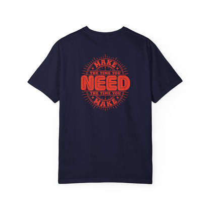 A navy blue short-sleeve crewneck t-shirt with a red circular graphic on the back that reads 'MAKE THE TIME YOU NEED THE TIME YOU MAKE'.