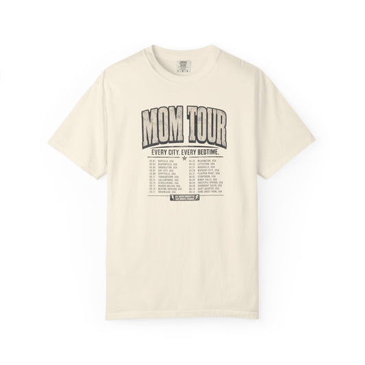An ivory short-sleeve t-shirt with a vintage-style black graphic print on the front reading 'MOM TOUR' and a tour schedule list below it.