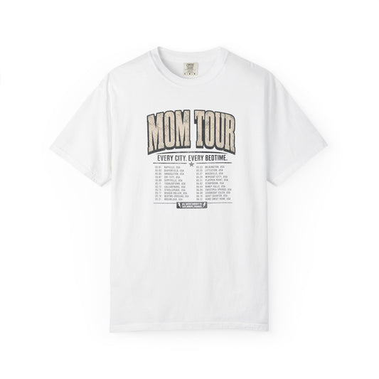 A white t-shirt with the text "MOM TOUR" EVERY CITY EVERY BEDTIME printed on the front