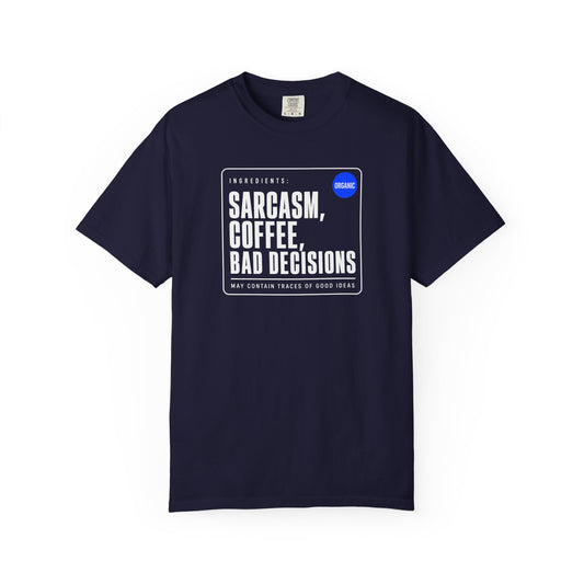 A navy short-sleeve crewneck t-shirt with a white rectangular graphic on the chest. The graphic features the text 'SARCASM, COFFEE, BAD DECISIONS' in bold white letters, with 'Ingredients' and 'May Contain Traces of Good Ideas' in smaller text, and a small blue circle containing the word 'ORGANIC'.