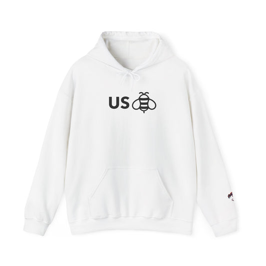A white pullover hoodie with a black graphic on the chest reading 'US' next to a bee illustration, and a small embroidered logo on the left sleeve, shown against a plain white background.