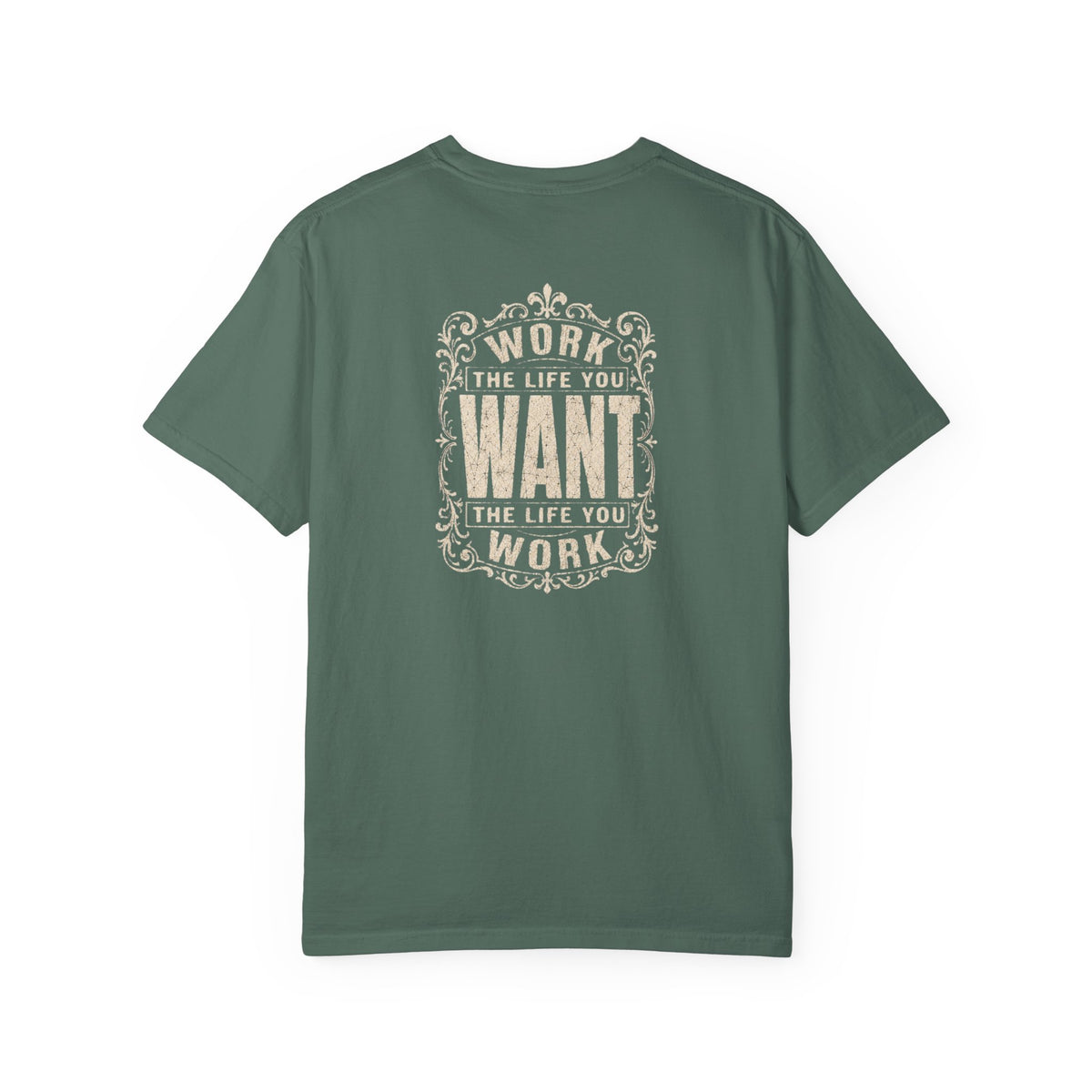 A green short-sleeve crewneck t-shirt with a dark white graphic print on the back. The graphic features the motivational quote 'WORK THE LIFE YOU WANT THE LIFE YOU WORK' in a decorative, vintage-style frame.