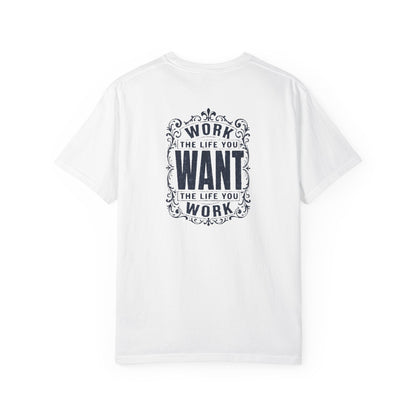 A white short-sleeve crewneck t-shirt with a dark navy blue graphic print on the back. The graphic features the motivational quote 'WORK THE LIFE YOU WANT THE LIFE YOU WORK' in a decorative, vintage-style frame.