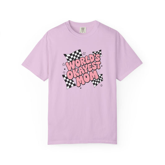 A light purple short-sleeve t-shirt with a graphic on the chest that reads 'WORLD'S ORKAVEST MOM' in pink bubble letters over a black-and-white checkered flag design, displayed on a clean white background.